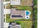 Aerial view of a well-maintained home featuring a pool, solar panels, and a large yard, showcasing property features at 485 Halter Dr, Apopka, FL 32712