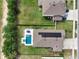 An aerial shot of a home with pool and solar panels, positioned on a grassy lot in a residential neighborhood at 485 Halter Dr, Apopka, FL 32712