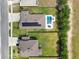 An aerial view showing a home with solar panels, a pool, and green yard space at 485 Halter Dr, Apopka, FL 32712