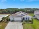 Aerial view of a home with a three-car garage, a long driveway, and lush green yard at 485 Halter Dr, Apopka, FL 32712