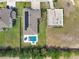 An aerial view reveals a house with a backyard pool, solar panels, and a fenced yard, highlighting outdoor amenities at 485 Halter Dr, Apopka, FL 32712