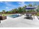 Spacious backyard with a pool, spa, and dining area, providing ample space for outdoor activities and enjoyment at 485 Halter Dr, Apopka, FL 32712