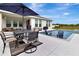 The house boasts a backyard featuring a pool, spa, and outdoor dining space, complete with comfortable lounge seating at 485 Halter Dr, Apopka, FL 32712