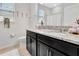 Bathroom featuring double granite vanity sinks, window, and bath with shower at 485 Halter Dr, Apopka, FL 32712
