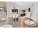Elegant dining area with seating and views into the kitchen, featuring modern decor and finishes at 485 Halter Dr, Apopka, FL 32712