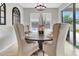 Stylish dining room with pool view features a chandelier and seating, perfect for entertaining at 485 Halter Dr, Apopka, FL 32712