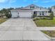 Well-maintained single-story home featuring a three-car garage and spacious driveway at 485 Halter Dr, Apopka, FL 32712