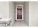 Covered entryway with a rich wood front door and sidelight at 485 Halter Dr, Apopka, FL 32712