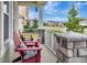 Inviting front porch with red Adirondack chairs and stone pillar accents at 485 Halter Dr, Apopka, FL 32712