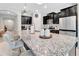 Spacious kitchen features a large granite island, modern appliances, and dark cabinets at 485 Halter Dr, Apopka, FL 32712