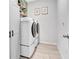 Well-equipped laundry room features a modern washer and dryer, built-in shelving, and stylish decor at 485 Halter Dr, Apopka, FL 32712