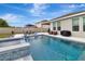 Inviting pool and spa with a dining set on the patio, creating a relaxing outdoor oasis for Gathering and friends at 485 Halter Dr, Apopka, FL 32712