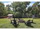 Expansive backyard featuring an outbuilding, firepit, play set, and ample green space at 4920 Sw 4Th Cir, Ocala, FL 34471