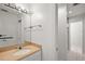 Well-lit bathroom featuring a large mirror, a single sink vanity, and tiled floors at 4920 Sw 4Th Cir, Ocala, FL 34471