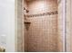 Inside the tiled shower enclosure, a shower head and shelf offer convenience and style at 4920 Sw 4Th Cir, Ocala, FL 34471