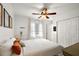 This bedroom is decorated with a ceiling fan, soft colors, and natural light at 4920 Sw 4Th Cir, Ocala, FL 34471