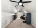 Large bonus room features neutral carpet, closet, ceiling fans, a work desk and storage at 4920 Sw 4Th Cir, Ocala, FL 34471