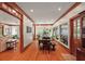 Bright dining room featuring wood floors, a large table, bench seating, and views to the outside at 4920 Sw 4Th Cir, Ocala, FL 34471