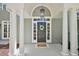 Welcoming front door with decorative wreath, framed by elegant columns and a covered entryway at 4920 Sw 4Th Cir, Ocala, FL 34471