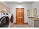Well-equipped laundry room with front loading washer/dryer and granite counters at 4920 Sw 4Th Cir, Ocala, FL 34471