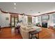 Bright living room featuring hardwood floors, fireplace, and large sectional sofa at 4920 Sw 4Th Cir, Ocala, FL 34471