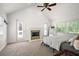 Spacious main bedroom featuring a fireplace, natural light, and two exterior doors at 4920 Sw 4Th Cir, Ocala, FL 34471