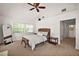 Bright main bedroom with neutral tones, natural light, and a large mirror at 4920 Sw 4Th Cir, Ocala, FL 34471
