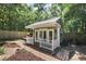 Quaint outbuilding with a deck, double doors, and fresh paint, adding charm at 4920 Sw 4Th Cir, Ocala, FL 34471