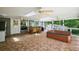 Spacious sunroom featuring tile floor, multiple ceiling fans and adjacent hot tub at 4920 Sw 4Th Cir, Ocala, FL 34471