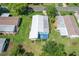 Aerial view showcasing backyard patio and lush landscaping at 501 Santa Fe Rd, Tavares, FL 32778
