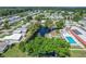 Aerial view of community featuring pool, pond, and lush greenery at 501 Santa Fe Rd, Tavares, FL 32778