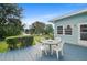 Back deck with outdoor seating area overlooking a pond and the well-maintained backyard at 501 Santa Fe Rd, Tavares, FL 32778