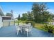 Back deck with outdoor seating area overlooking a pond and the well-maintained backyard at 501 Santa Fe Rd, Tavares, FL 32778