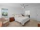 Bright bedroom with a ceiling fan, a cozy chair, and natural light through the windows at 501 Santa Fe Rd, Tavares, FL 32778
