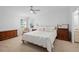 Spacious bedroom featuring a ceiling fan, natural light, and comfortable furniture at 501 Santa Fe Rd, Tavares, FL 32778