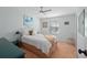 Comfortable bedroom with a cozy bed, ceiling fan, and natural light from the window at 501 Santa Fe Rd, Tavares, FL 32778