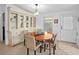 Cozy dining area featuring a round wooden table, chairs, and a built-in cabinet with glass doors at 501 Santa Fe Rd, Tavares, FL 32778