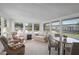 Inviting sun room with ample natural light, a table, and comfortable seating for relaxation at 501 Santa Fe Rd, Tavares, FL 32778