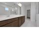 Well-lit bathroom featuring double vanity with large mirror, glass shower, and tile flooring at 5173 Waypointe Blvd, Apopka, FL 32712
