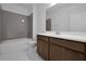 Bright bathroom featuring a shower-tub combo with gray tile surround and vanity with solid surface countertop at 5173 Waypointe Blvd, Apopka, FL 32712