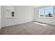 Bright bedroom with plush carpeting, two large windows, and ample natural light at 5173 Waypointe Blvd, Apopka, FL 32712