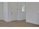 Inviting entryway featuring light wood-look flooring, white walls, and a classic front door at 5173 Waypointe Blvd, Apopka, FL 32712
