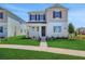 Charming two-story home with manicured lawn and inviting entrance, showcasing curb appeal at 5173 Waypointe Blvd, Apopka, FL 32712