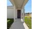 Inviting front porch with supportive columns and a freshly painted front door at 5173 Waypointe Blvd, Apopka, FL 32712