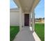 Inviting front porch with supportive columns and a freshly painted front door at 5173 Waypointe Blvd, Apopka, FL 32712