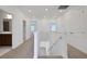 Bright upstairs hallway with neutral carpet, white walls, and access to other rooms at 5173 Waypointe Blvd, Apopka, FL 32712