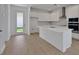 Open kitchen with an island, quartz countertops and an adjacent outdoor door at 5173 Waypointe Blvd, Apopka, FL 32712