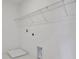 White laundry room with wire shelving and connections for appliances, ready for customization at 5173 Waypointe Blvd, Apopka, FL 32712