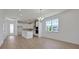 Bright living room with wood floors and island kitchen with modern appliances at 5173 Waypointe Blvd, Apopka, FL 32712