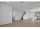 Bright and spacious living room with wood floors, recessed lighting, and a staircase at 5173 Waypointe Blvd, Apopka, FL 32712